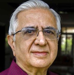 an older man wearing glasses and smiling, senior citizen, Kishan S. Rana