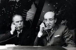 Peter Sellers as Dr Strangelove, holding a telephone, talking to his Russian counterpart