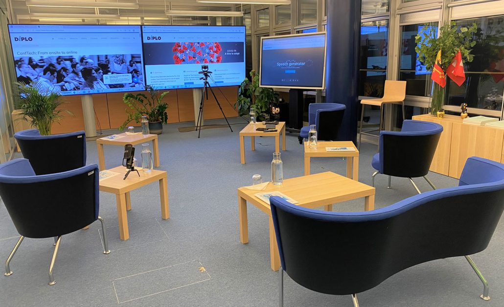 Office furniture in Geneva's Conftech Lab with three screens in the back